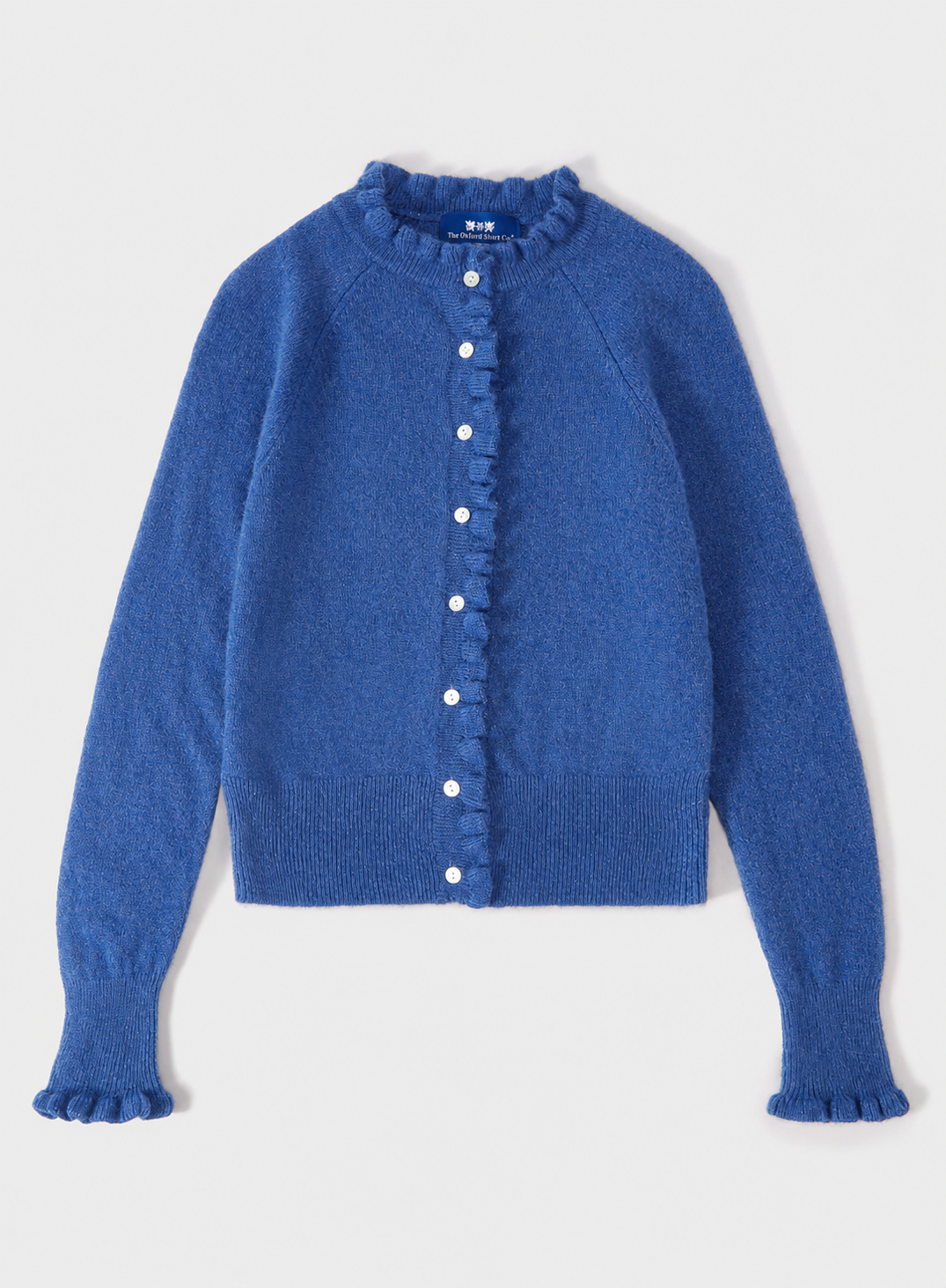 A blue knit cardigan sweater with a ruffled collar, ruffled button placket, and ruffled cuffs, shown flat on a light gray background.
