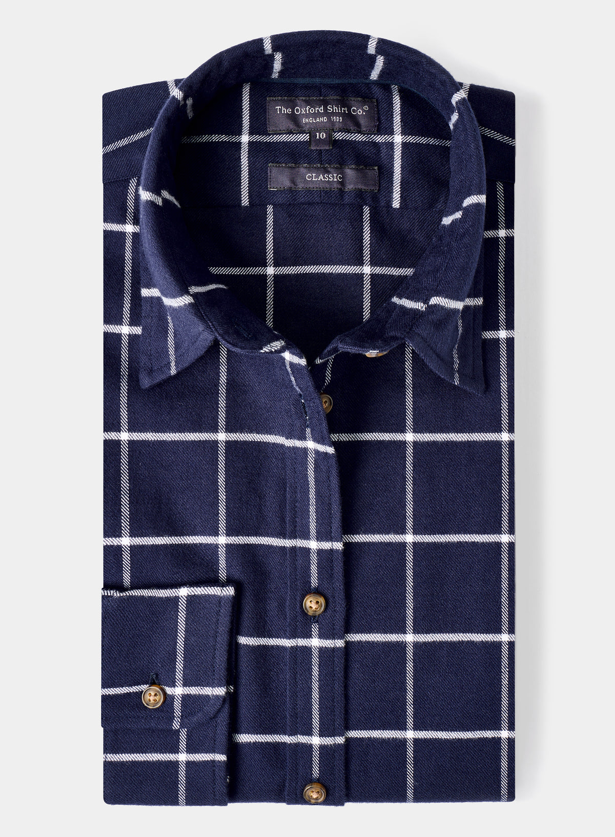 Folded navy blue shirt with white check pattern on a light gray background