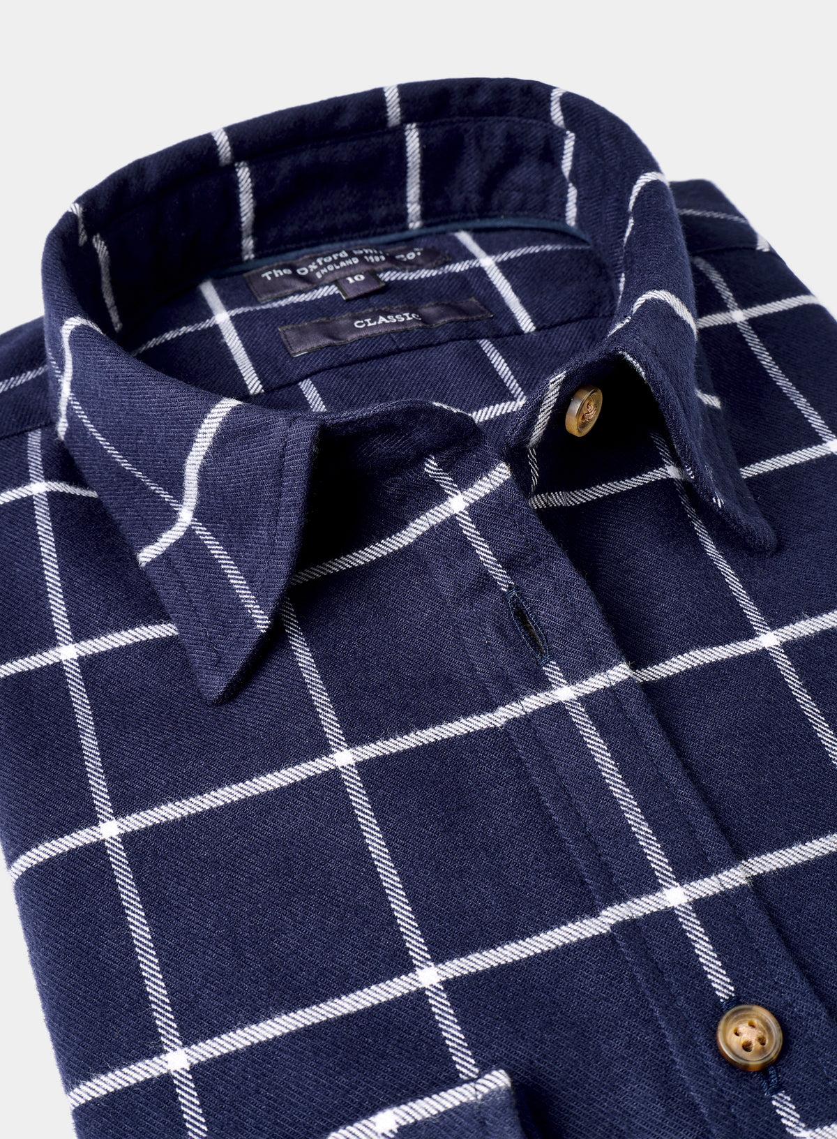 Navy blue shirt with white checkered pattern on a white background