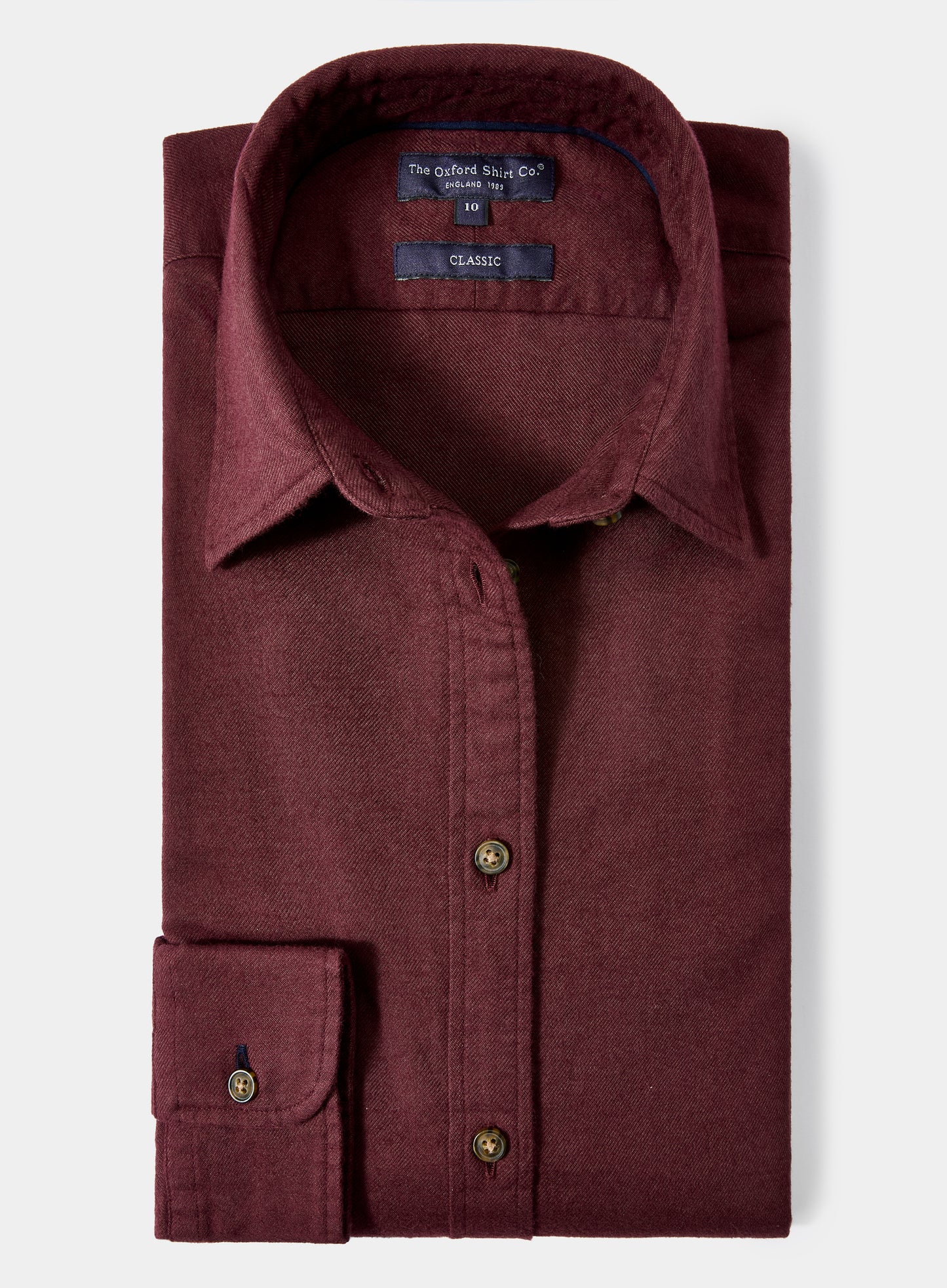 Maroon shirt with button details on a light gray background