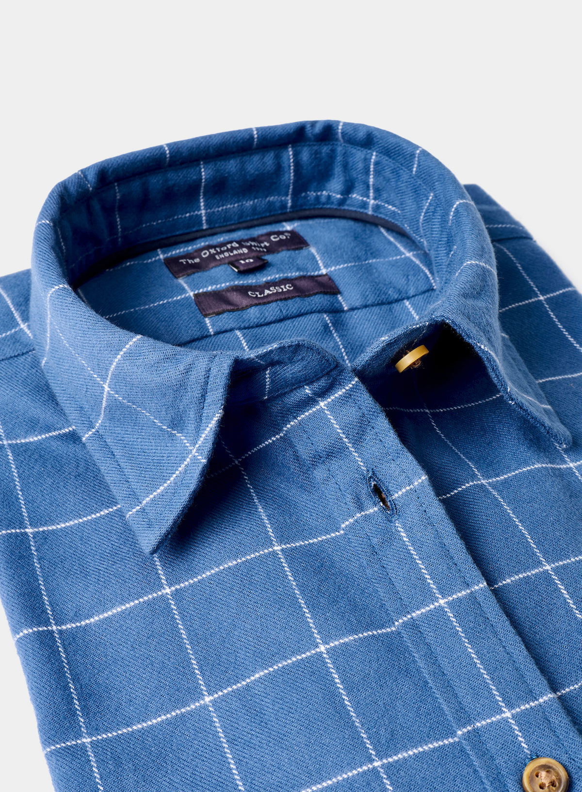 Blue checkered shirt with collar and button details on a white background