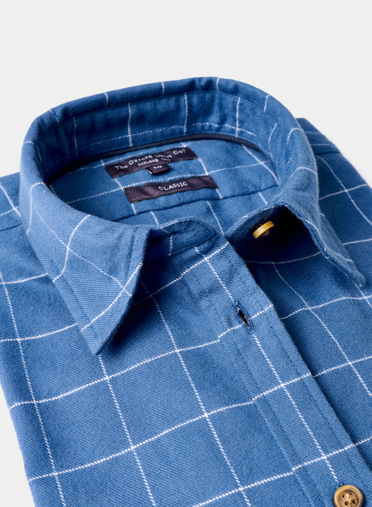 Blue checkered shirt with collar and button details on a white background