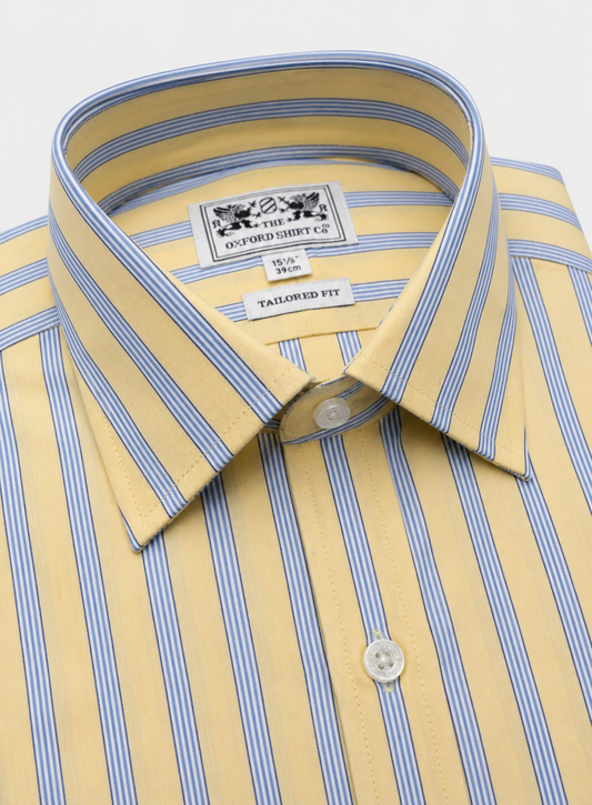 A close-up of a yellow short-sleeve dress shirt with thin blue vertical stripes, featuring a pointed collar, white buttons, and an inner neck label for Oxford Shirt Co.