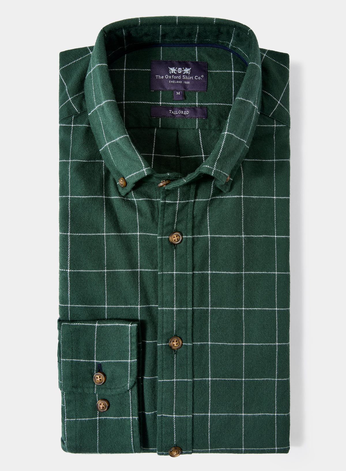 Green checkered shirt with brand label on a light gray background