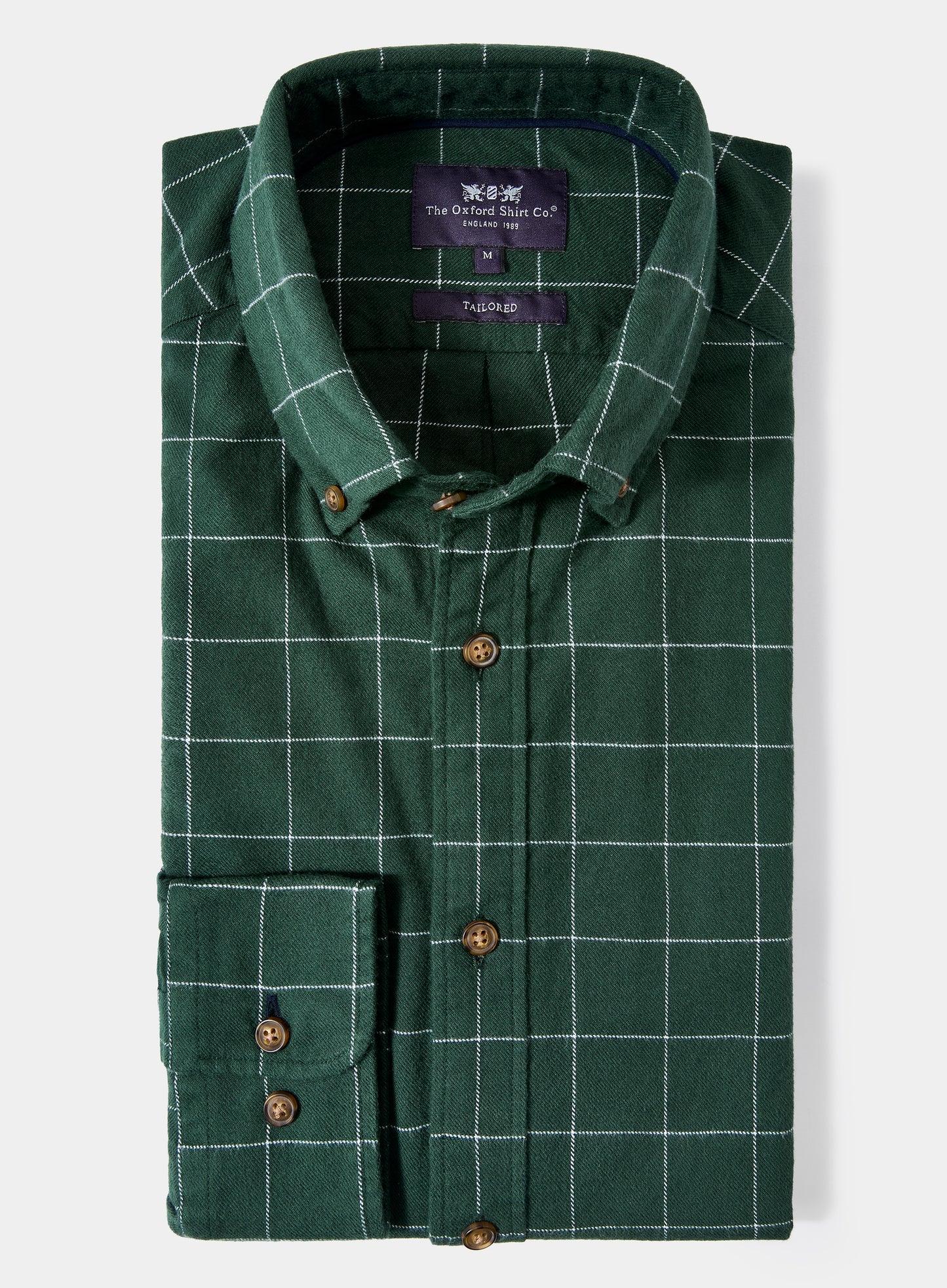 Green checkered shirt with brand label on a light gray background