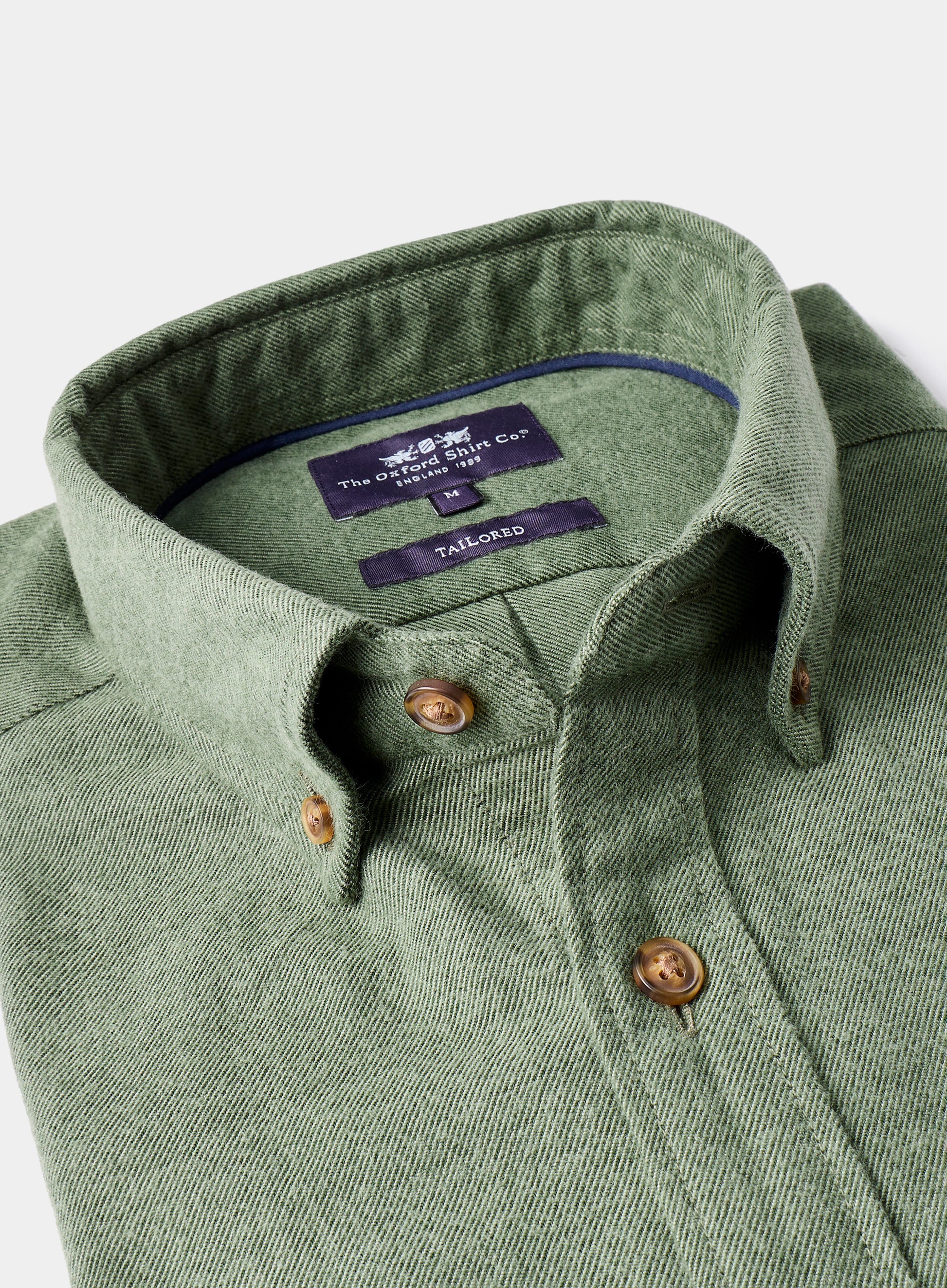 Green shirt with collar and buttons on a white background