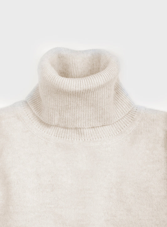 Women’s cashmere roll neck jumper in Ecru.