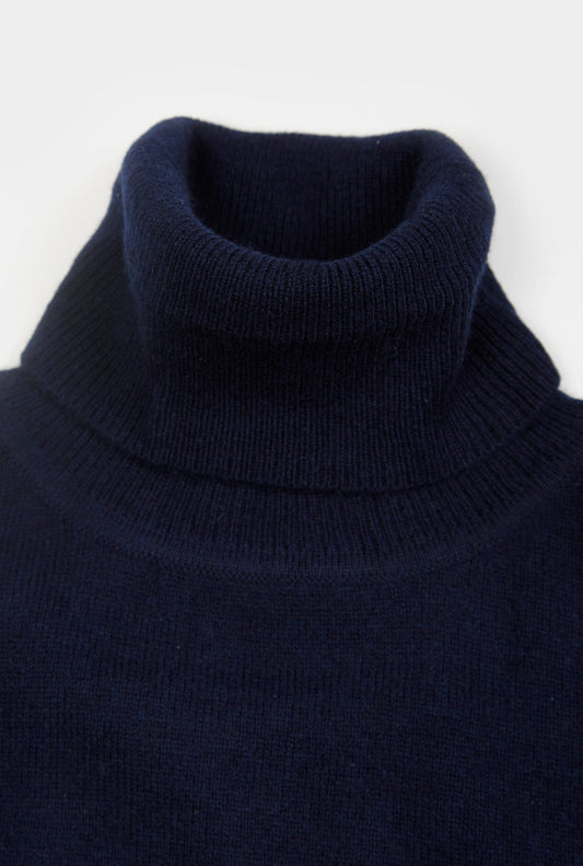Women’s cashmere roll neck jumper in Navy.
